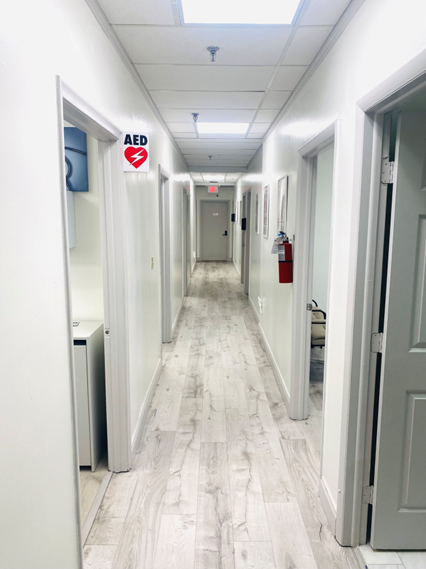 MediPlus Clinic clean hallway with AED safety equipment