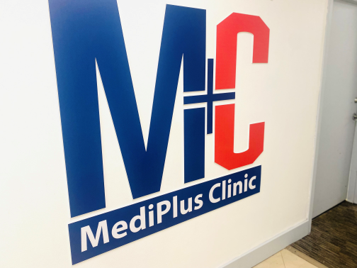 MediPlus Clinic lobby with large logo wall